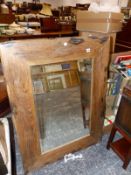 A RUSTIC OAK FRAME MIRROR.