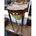 A REGENCY STYLE MAHOGANY AND INLAID SEWING TABLE ON SLENDER TURNED LEGS.