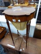 A REGENCY STYLE MAHOGANY AND INLAID SEWING TABLE ON SLENDER TURNED LEGS.