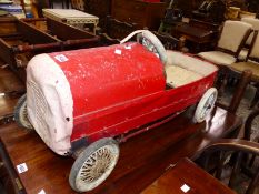 A VINTAGE TIN PLATE PEDAL CAR.