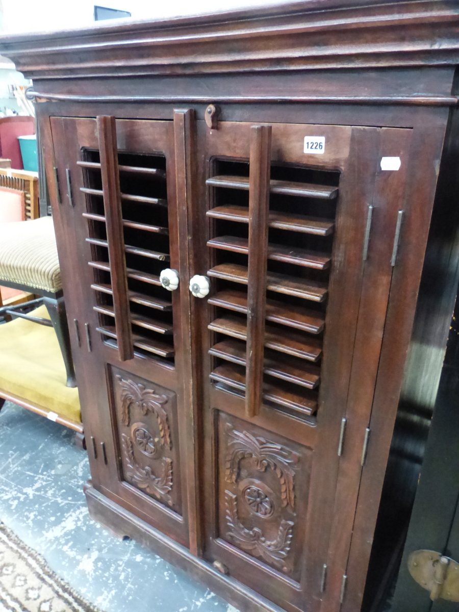 A HARDWOOD SIDE CABINET WITH CARVED AND LOUVRE DOORS. W 92 X D 65 X H 130CMS.