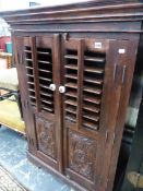 A HARDWOOD SIDE CABINET WITH CARVED AND LOUVRE DOORS. W 92 X D 65 X H 130CMS.