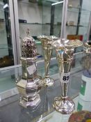 A HALLMARKED SILVER CASTER AND TWO SILVER HALLMARKED LOADED SPILL FLARED VASES.