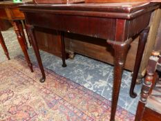 A 19TH C. HEAVY MAHOGANY FOLD OVER CARD TABLE ON TURNED AND CARVED SUPPORTS WITH CLUB FEET. W 88 X D