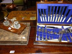 TWO CUTLERY CASES WITH VARIOUS PLATED CUTLERY, A VINTAGE DESK STAND HOLDING TWO CUT GLASS INK