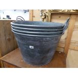 A SET OF FOUR LARGE TWO HANDLED GALVANIZED PLANTERS / BUCKETS.