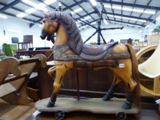 A VINTAGE STYLE PAINTED TOY HORSE ON WHEELS.