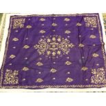 A PURPLE SILK PANEL, POSSIBLY TURKISH, WORKED IN GOLD THREAD WITH FLORAL MEDALLION AND SPANDRELS AND
