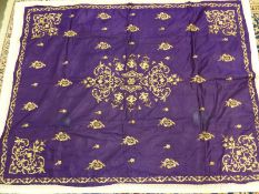 A PURPLE SILK PANEL, POSSIBLY TURKISH, WORKED IN GOLD THREAD WITH FLORAL MEDALLION AND SPANDRELS AND