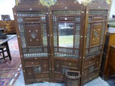 AN EARLY 20th C. MIDDLE EASTERN HARDWOOD THREE FOLD SCREEN, THE ARCHED TOP TO EACH PANEL INLAID WITH