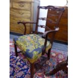 A GEORGE III MAHOGANY TRIPLE PIERCED LADDER BACKED ELBOW CHAIR, THE FLORAL NEEDLE WORKED SEAT