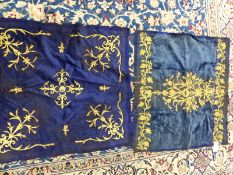 TWO BLUE SILK VELVET PANELS WORKED IN GOLD THREAD THE DARKER WITH VINE MEDALLION AND SPANDRELS. 85 x