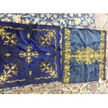 TWO BLUE SILK VELVET PANELS WORKED IN GOLD THREAD THE DARKER WITH VINE MEDALLION AND SPANDRELS. 85 x
