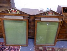 A PAIR OF VICTORIAN GLAZED OAK NOTICE BOARDS, VR AND A CROWN PAINTED WITHIN THE TRIANGULAR PEDIMENTS