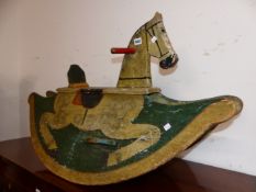 AN ANTIQUE CHILD'S CREAM PAINTED ROCKING HORSE, THE REAL HAIR TAIL BETWEEN HALF ROUND BOARDS PAINTED