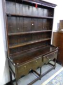 A 19th C. OAK DRESSER, THE ENCLOSED THREE SHELF BACK ON A BASE WITH TWO DRAWERS, A WAVY APRON AND