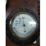 AN OAK FRAMED NEGRETTI AND ZAMBRA ANEROID BAROMETER WITH A MERCURY THERMOMETER. Dia. 26cms. TOGETHER