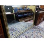 A LARGE GILT FRAMED MIRROR.