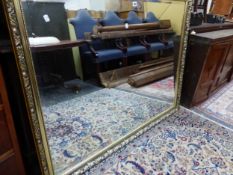 A LARGE GILT FRAMED MIRROR.