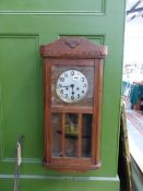 A 1930'S OAK CASED WALL CLOCK.