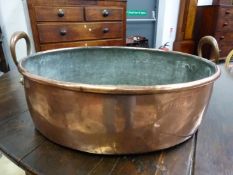 A LATE VICTORIAN COPPER TWO HANDLED OVAL LARGE OVAL PAN. W 58cms.