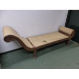 A TEAK CHAISE LONGUE, POSSIBLY BURMESE, THE SCROLL ENDS AND SEAT CANED IN GEOMETRIC PATTERNS ABOVE