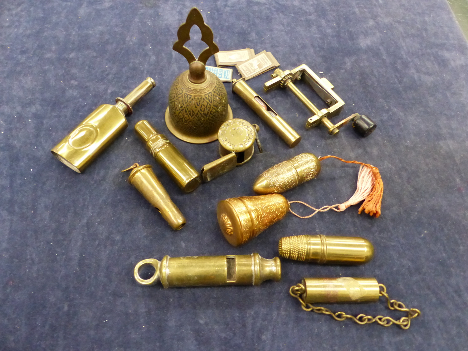 A QUANTITY OF BRASS SEWING ACCOUTREMENTS, WHISTLES, A STAMP PRESS ETC