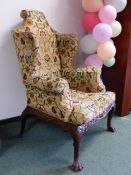 A PAIR OF VINTAGE IRISH QUEEN ANNE STYLE MAHOGANY WING ARMCHAIRS WITH FOLIATE CARVED SEAT RAILS AB