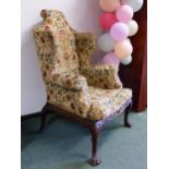 A PAIR OF VINTAGE IRISH QUEEN ANNE STYLE MAHOGANY WING ARMCHAIRS WITH FOLIATE CARVED SEAT RAILS AB