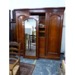 A VICTORIAN MAHOGANY TRIPLE COMPACTUM WARDROBE WITH MIRRORED DOOR.