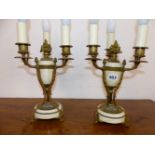 A PAIR OF ORMOLU AND WHITE MARBLE TRIPLE LIGHT TABLE TAMPS, EACH WITH THREE PINE CONES ON THE