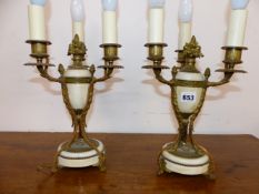 A PAIR OF ORMOLU AND WHITE MARBLE TRIPLE LIGHT TABLE TAMPS, EACH WITH THREE PINE CONES ON THE