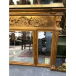 A REGENCY STYLE GILT OVER MANTLE MIRROR.