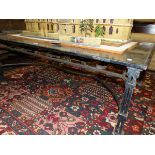 A GLASS TOPPED WROUGHT IRON COFFEE TABLE, THE LEGS JOINED BY A FOLIATE TIER BELOW THE GLASS. W 129 x