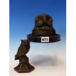TWO BRONZED SPELTER OWL INKWELLS BOTH WITH GLASS EYES, THE LARGER A HEAD ONLY MOUNTED ON AN EBONISED