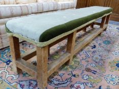 A GEORGIAN STYLE TWO TONE GREEN UPHOLSTERED BENCH, THE SQUARE SECTIONED LEGS AND CONJOINING