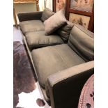 A HOWARD KEIL SETTEE WITH SQUARED BACK AND ARMS UPHOLSTERED IN BROWN. W 225cms.