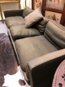 A HOWARD KEIL SETTEE WITH SQUARED BACK AND ARMS UPHOLSTERED IN BROWN. W 225cms.