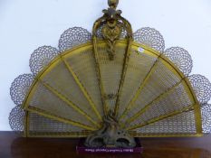 A 19th C. BRASS FAN FIRE GUARD, THE PIERCED LEAVES FANNING OUT BELOW A FOLIATE BALUSTER