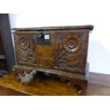 AN OAK COFFER WITH THE FRONT CARVED WITH TWO FLOWER STEMS FLANKING 1671 AND E P ABOVE WAVY BRACKET