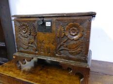 AN OAK COFFER WITH THE FRONT CARVED WITH TWO FLOWER STEMS FLANKING 1671 AND E P ABOVE WAVY BRACKET