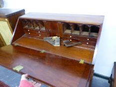A GEORGE III MAHOGANY BUREAU, THE FALL ENCLOSING PIGEON HOLES AND DRAWERS FLANKING THE CENTRAL