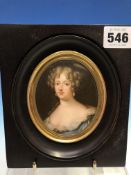 A PORTRAIT MINIATURE ON PORCELAIN DEPICTING LOUISE DE LA VALLIERE IN A BLACK WOOD FRAME. 16 x