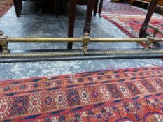 A CAST IRON AND BRASS RAIL FENDER.