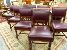 A SET OF EIGHT EDWARDIAN WALNUT LEATHER DINING CHAIRS, THE SQUARED BACKS UPHOLSTERED IN RED ABOVE OP