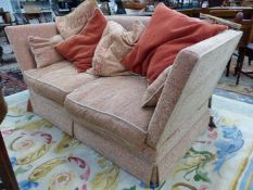 TWO KNOLE SETTEES, ONE WITH THREE SEATS AND THE OTHER WITH TWO UPHOLSTERED IN PINK GROUND WHITE FLOR