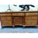 A VICTORIAN MAHOGANY TOPPED PINE DRESSER, THE THREE CURVE FRONTED DRAWERS ABOVE A CENTRAL RECESSED
