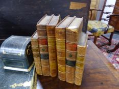 A PAIR OF BOOKENDS, EACH FORMED OF THREE LEATHER BOUND CLASSICAL BOOKS GLUED TOGETHER