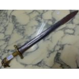 A DOUBLE EDGED BLADE WITH BRASS QUILLON AND HANDLE, THE LION MASK POMMEL WITH RING IN ITS MOUTH. W