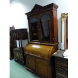 A 19th C. MAHOGANY CYLINDER BUREAU BOOKCASE, TRIANGLES TOPPING THE PEDIMENT, THE GLAZED DOORS AND